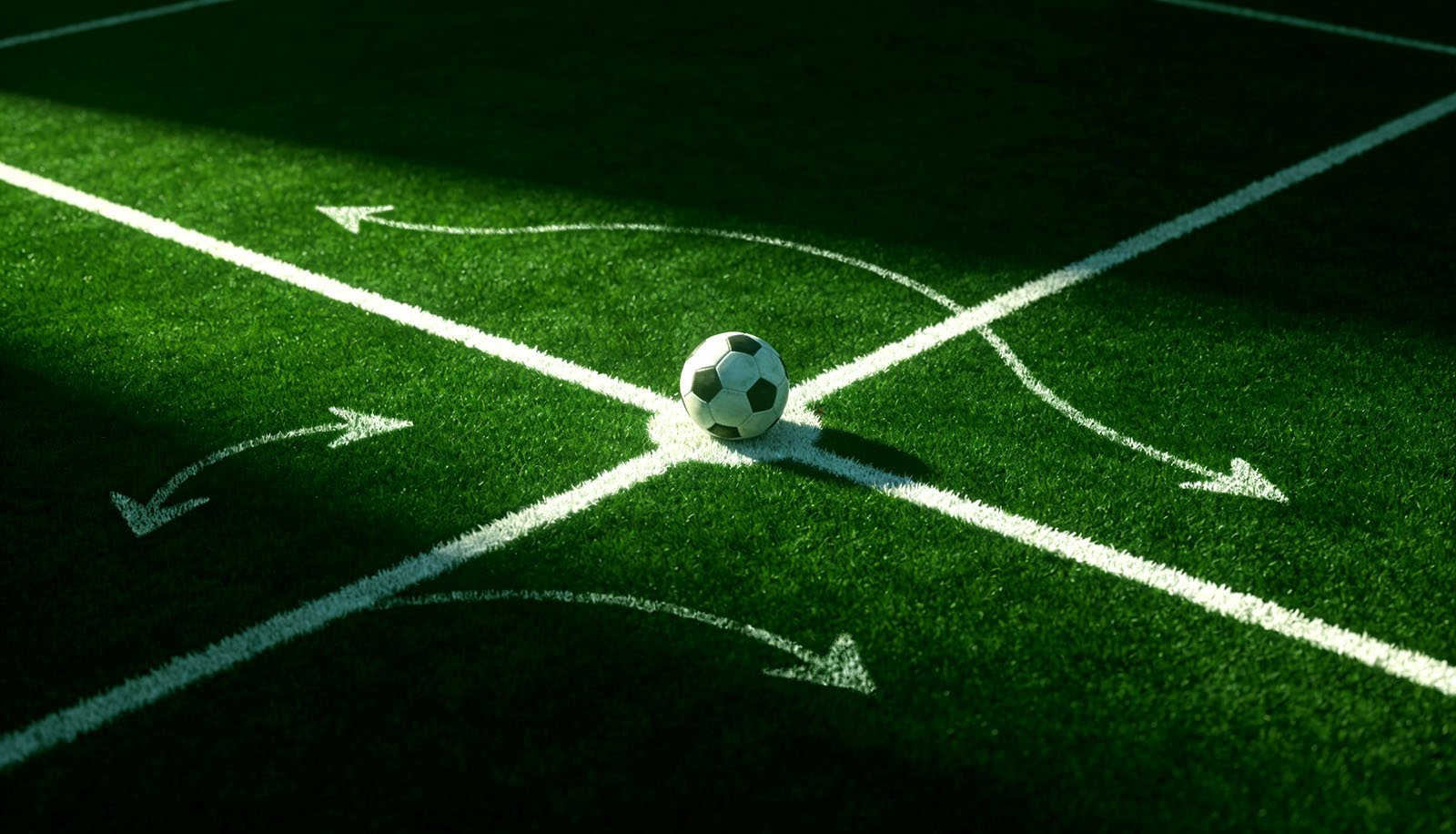 Chalk tactical arrows drawn around a soccer ball on the center spot